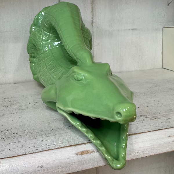 croc gluggle jug in apple green lay on a woodend shelf