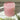 Dusky pink rustic pillar candle from Grand Illusions, showing a tall, textured wax candle with a natural, matte finish.