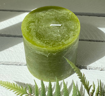 Fern green rustic pillar candle by Grand Illusions, 100x100mm, with textured wax surface and simple cylindrical shape.
