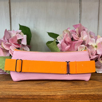 Pink and orange vegan leather pen pouch by Designworks Collective with pens inside, stylish storage for writing tools.