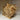 Textured animal head sculpture on a wooden base against a neutral background