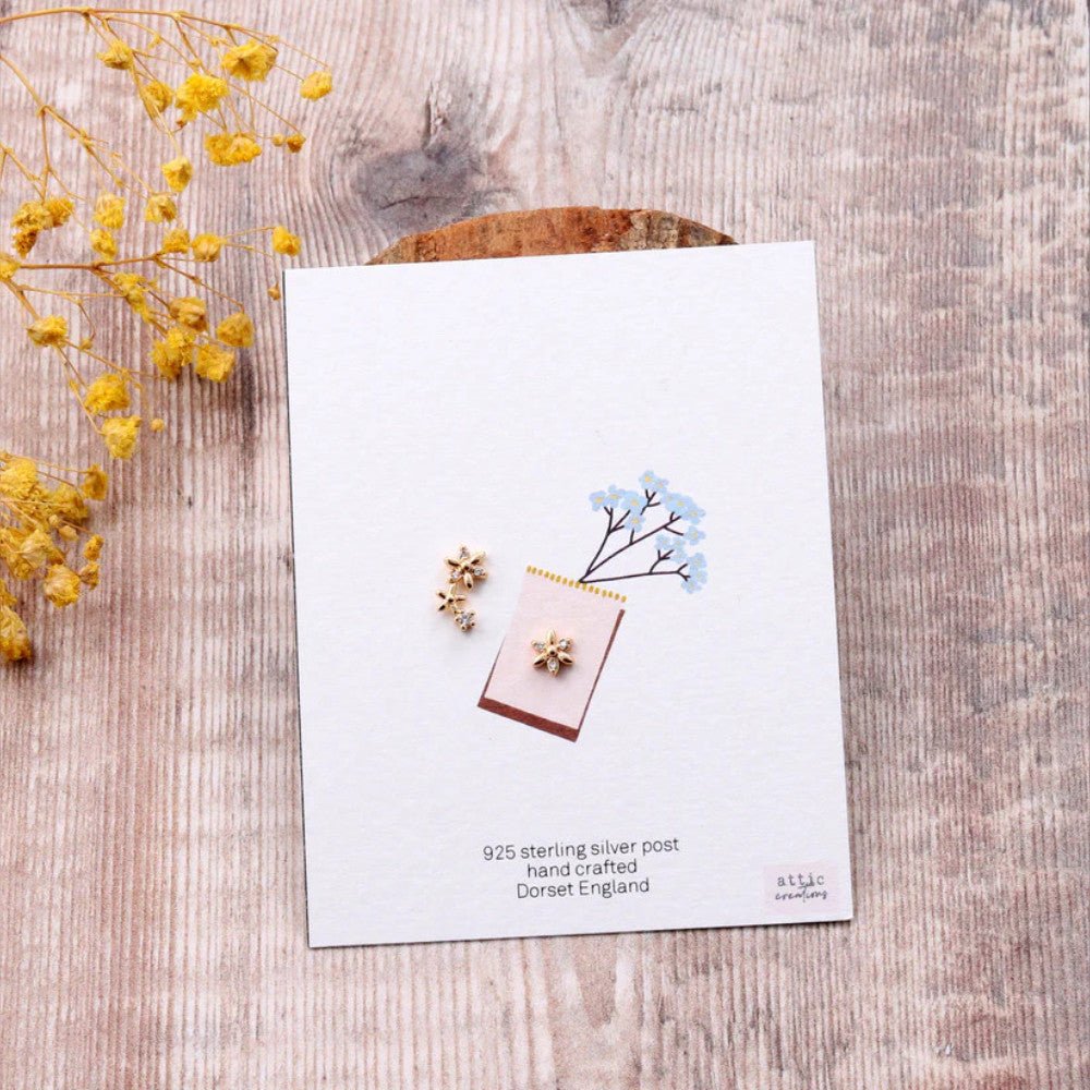 Gold asymmetric flower earrings by Attic Creations featuring unique floral design and elegant craftsmanship.