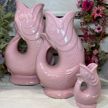 Baby pink Mini Gluggle Jug by The Gluggle Jug Factory, featuring a small ceramic jug with a distinctive spout and playful design.