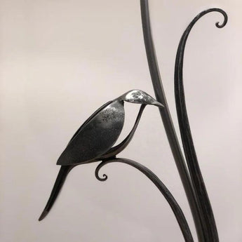 Forged bird table lamp by Belltree Forge featuring a decorative metal design and a sturdy base for outdoor or indoor use.