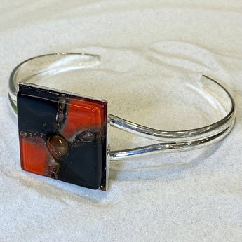 Black and red glass bangle from Bumble Living, showcasing a shiny, smooth finish and stylish design.