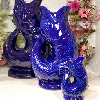 Blue Original Gluggle Jug Mini from The Gluggle Jug Factory, featuring a vibrant blue ceramic design with a distinctive spout and handle.
