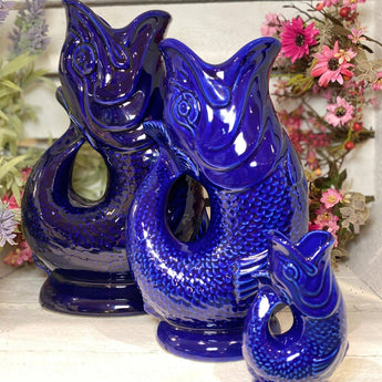 Blue Original Gluggle Jug XL by The Gluggle Jug Factory, showcasing a vibrant blue ceramic decorative water jug with a traditional design.