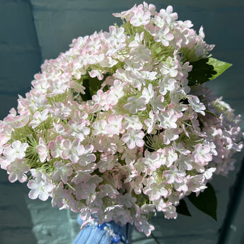Pale pink artificial Charlotte spray flower on single stem by Lotus Imports Ltd, realistic faux floral for arrangements.