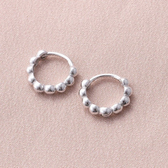 Silver beaded hoop earrings by Attic Creations, showcasing classic round design with silver beads and polished finish.