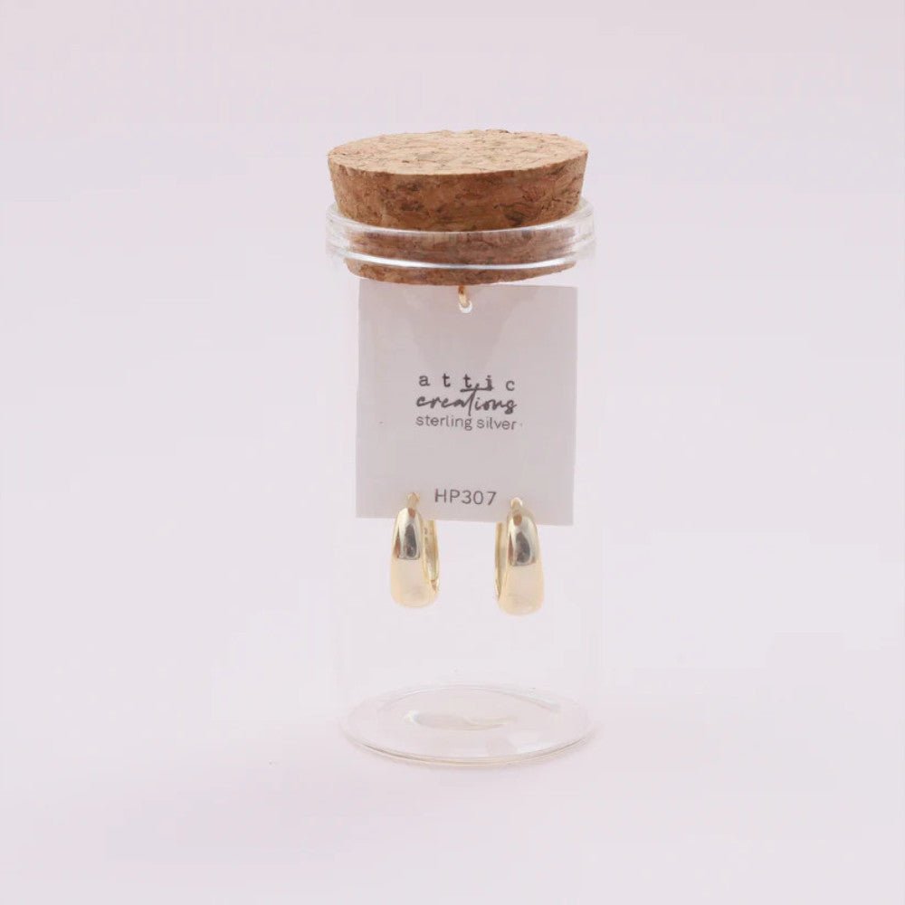 Gold hoop earrings by Attic Creations, featuring slim to wide design, displayed on a neutral background.