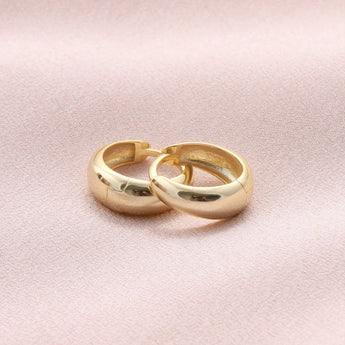 Gold hoop earrings from Attic Creations featuring a classic slim to wide design, showcasing a stylish and versatile jewelry piece.