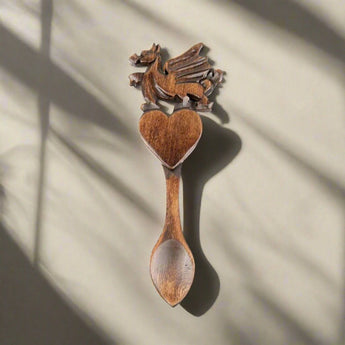 Welsh Love Spoon with carved dragon and heart motifs by Cadwyn Ltd, traditional Welsh wooden love symbol.