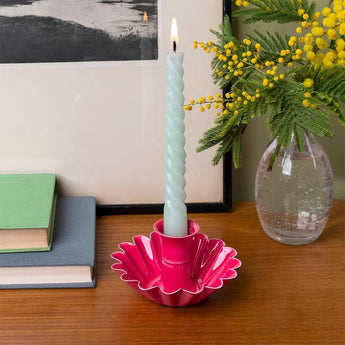 Vibrant pink enamel cupped flower candle holder with a floral design, ideal for decorative candle display.