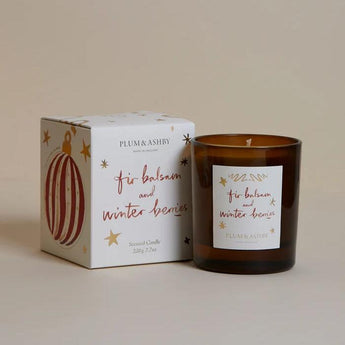 Plum & Ashby Fir Balsam & Winter Berries scented candle in a glass jar with a natural wicking wick and festive design.