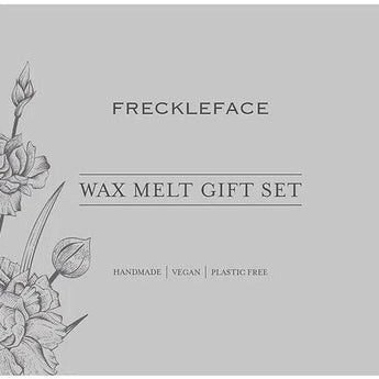 Freckleface wax melt gift set with colorful wax melts and a ceramic wax burner on a wooden surface.