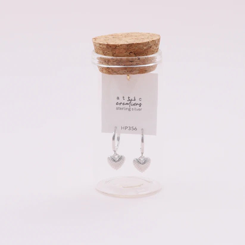 Silver hoop earrings with heart-shaped debossed detail from Attic Creations, showcasing a stylish and elegant jewelry design.