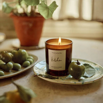 Plum & Ashby scented kitchen candle in a glass jar with a natural wax finish, designed to add a warm, inviting ambiance.