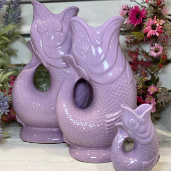 Lilac Original Gluggle Jug XL from The Gluggle Jug Factory, showcasing its large, decorative ceramic design with a spout and handle.