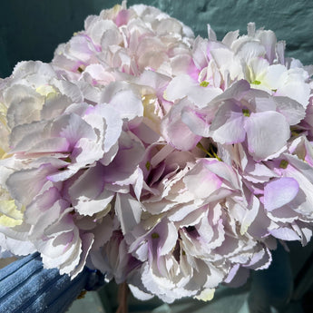 Artificial large mophead hydrangea stem in barely lilac color, Lotus Imports Ltd floral decor, realistic faux flowers for arrangements.