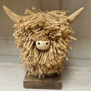A small Highland cow jute ornament named Morag by Aquarelle Home, featuring natural jute material and detailed animal design.