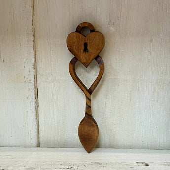 Welsh Love Spoon by Cadwyn Ltd featuring a heart-shaped padlock design, made of polished wood with intricate carvings.