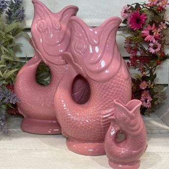 Pink mini Gluggle Jug by The Gluggle Jug Factory featuring a classic ceramic design and distinctive spouting spout.