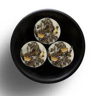 Freckleface RHS Botanic Lemon and Lavender wax melts in a clear container, showcasing yellow and purple wax pieces.