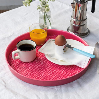 Vibrant pink round enamel trinket dish with a smooth finish, ideal for jewelry or small accessories.