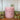 Rustic dusky pink pillar candle from Grand Illusions, showcasing a textured wax finish and classic cylindrical shape.