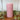 Rustic dusky pink pillar candle by Grand Illusions, 70x130mm, with textured surface and warm glow.