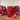 Rustic red pillar candle by Grand Illusions, 70x130mm, with a textured, rustic finish and a classic cylindrical shape.