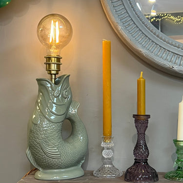 Sage-colored Gluggle Jug lamp with traditional design from The Gluggle Jug Factory, featuring a ceramic jug with spout and handle.