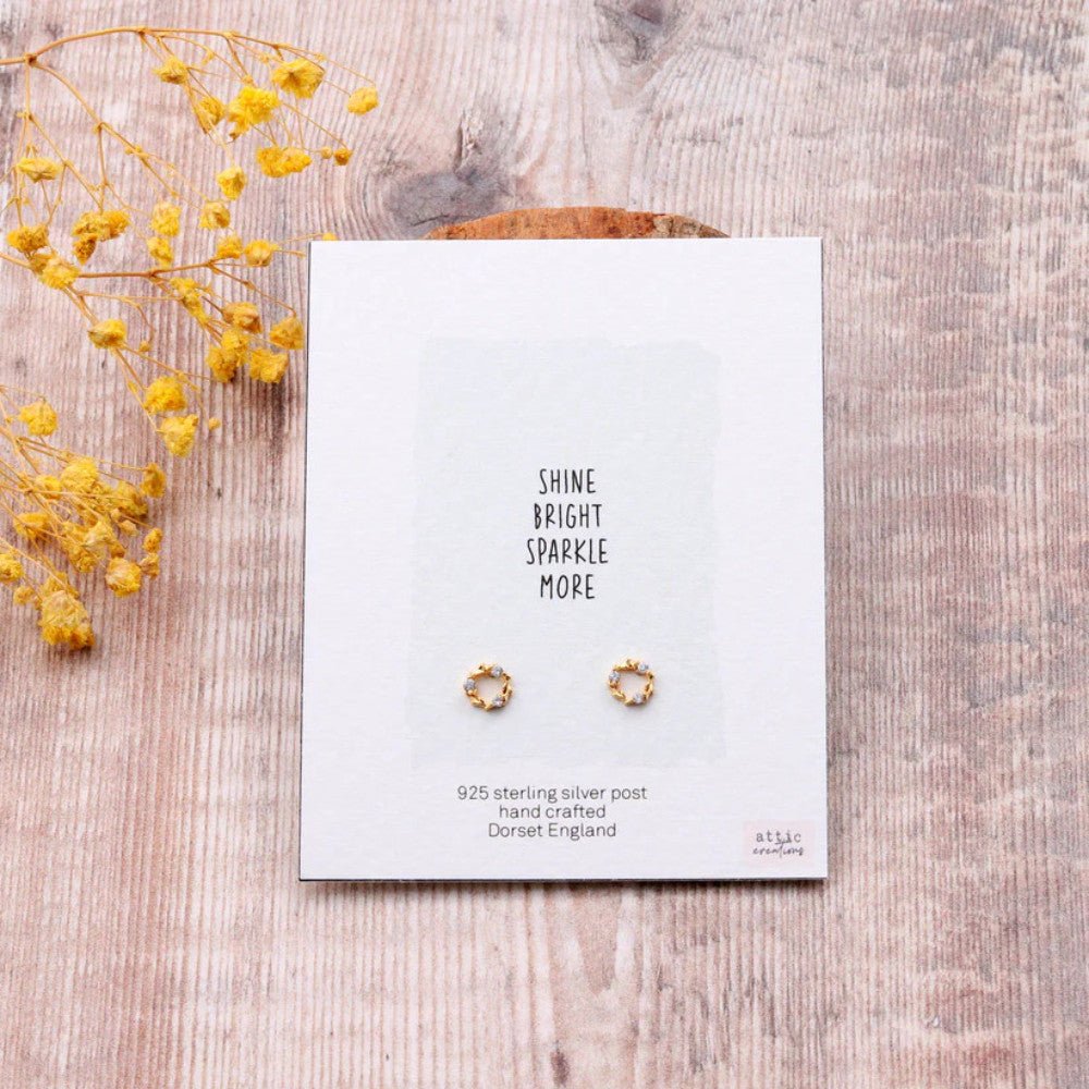 Gold earrings featuring a circular design with sparkling crystals from Attic Creations Shine Bright Crystal collection.