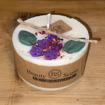 Small Lily of the Valley scented candle by Beauty Scents, featuring a white ceramic container and a lit wick for cozy ambiance.