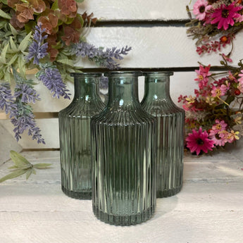 Colorful Snipe Stripe Glass Bottle Vase by Bumble Living, featuring vibrant striped design and a sleek, curved shape.
