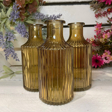 Colorful Snipe Stripe Glass Bottle Vase by Bumble Living, featuring a sleek design and vibrant assorted colors.