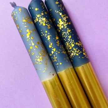 Set of three gold dip dye dinner candles from Colour Emporium with starry night pattern, perfect for elegant table settings.