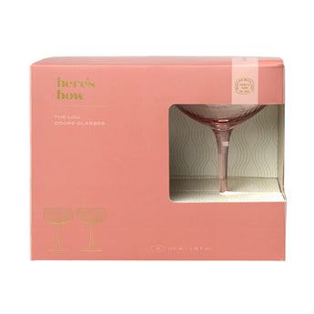 Set of two blush-colored The Lou Coupe wine glasses by Designworks Collective with elegant, rounded bowl design.