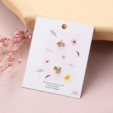 Gold earrings with three colorful crystal accents by Attic Creations, featuring vibrant, sparkling gemstone details.