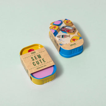 Block Design tinned sewing kit with scissors, needles, thread, and buttons inside a compact metal container.