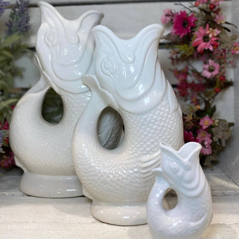 White original Gluggle Jug Mini with a classic shape and spout, showcasing its smooth ceramic finish and distinctive design.