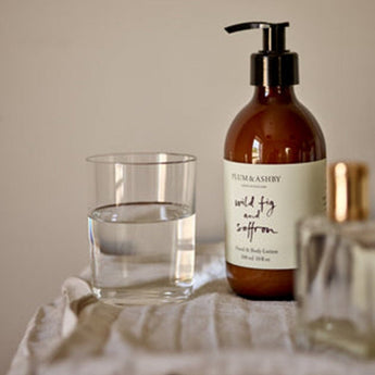 Plum & Ashby Wild Fig & Saffron Hand and Body Lotion bottle with a minimalist label and elegant packaging.