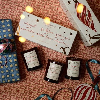 Set of scented winter votive candles by Plum & Ashby, featuring festive candle holders and warm, seasonal fragrances.