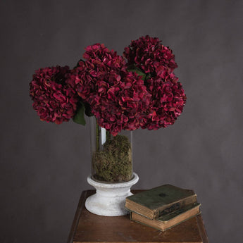 Artificial Autumn Ruby Hydrangea single stem from Hills Interiors, showcasing vibrant red and orange blooms with green leaves.