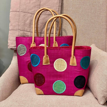 Small hot pink circle tote bag from Basket Basket, showing a stylish round design and compact size for everyday use.