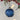 Diamond-cut blue bauble by Grand Illusions, showcasing a shiny, faceted glass ornament with intricate diamond pattern.