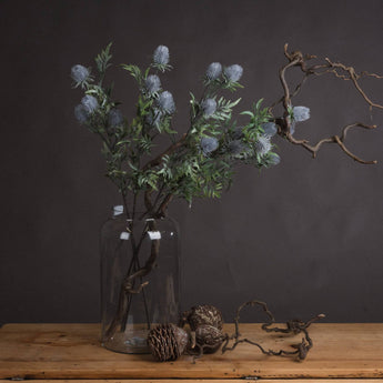 Single stem of Hills Interiors artificial Eryngium Blue Thistle faux flower with spiky blue blossoms on a realistic stem.