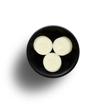 Freckleface Bergamot Vebena Soya Wax Melts showing scented wax pieces in a clear container with vibrant orange and green colors.