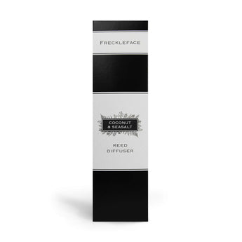 Freckleface Coconut & Sea Salt Reed Diffuser with a sleek glass bottle and natural reed sticks for home fragrance.