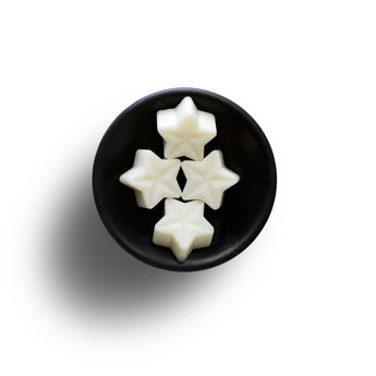 Freckleface Pomegranate Black Soya Wax Melts in a clear container, showcasing vibrant wax pieces with a pomegranate scent.